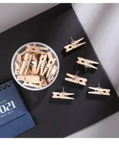 Gros plan de pinces à épingles en bois naturel sur une surface de bureau noire texturée