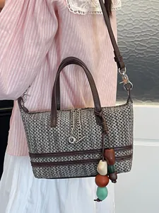Elegant hollow woven tote bag with brown leather straps and colorful bead charms decor