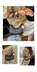 Elegant grey fabric and black leather contrast handbag with gold chain strap detail.