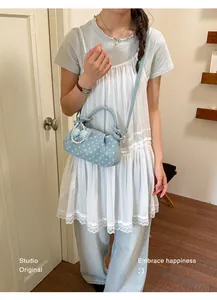 Exquisite light blue polka dot handbag for women featuring a pearl bow charm accessory