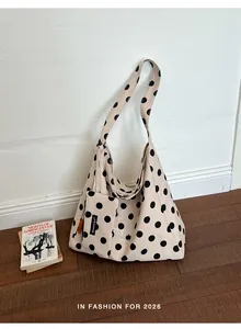 Stylish large capacity canvas tote bag with polka dot pattern shown in a room setting