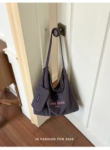 Large capacity purple canvas shoulder bag with a matching small pouch for daily commute