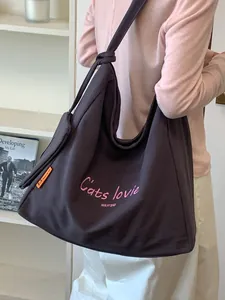 Large capacity canvas shoulder bag for women with pink embroidery and minimalist style