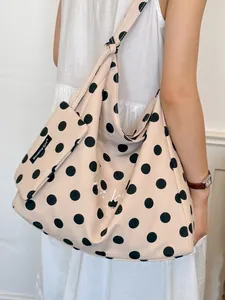 Large capacity canvas tote bag featuring black polka dots in a relaxed style for women