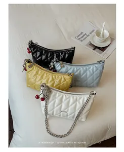 Detail view showing four elegant colors of quilted chain shoulder bags with cherry charms