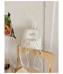 Sweet white backpack featuring red polka dots, delicate lace trim, and a bow detail