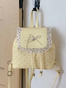 Sweet yellow polka dot backpack with lace trim and silver bow detail for women