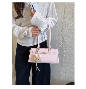 Elegant light pink underarm shoulder bag with cute teddy bear charm for daily commute