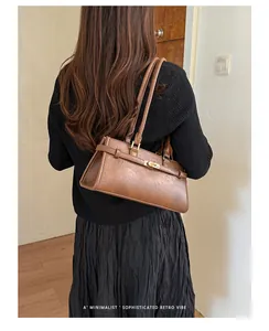 Sophisticated retro brown underarm tote bag worn by a model in a minimalist setting