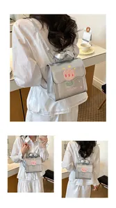 Vue détaillée d'un sac à dos argenté pour femme avec broderie tulipe et nœud.