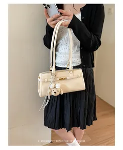 Sophisticated cream underarm tote bag with cute teddy bear charm styled in a retro outfit