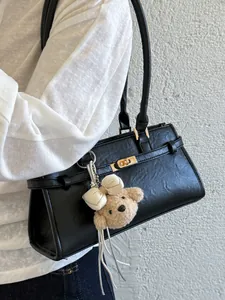 Minimalist black faux leather shoulder bag for women featuring a cute plush teddy bear charm