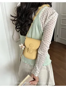 Vintage yellow saddle bag with flower charm detail for women in 2026 style.