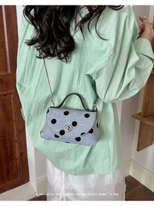 Gedetailleerd overzicht van een elegante lichtblauwe polka dot mini-crossbodytas