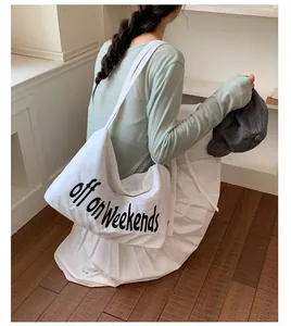 Lifestyle detail of a white large capacity nylon tote bag with off on weekends text print