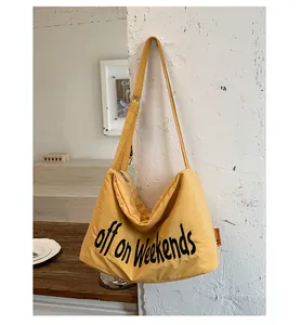 Close-up detail of yellow nylon casual tote bag featuring off on Weekends lettering print