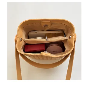 Detail view of woven bucket bag interior showing dual compartments and storage capacity.