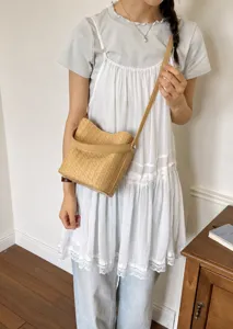 Stylish khaki woven bucket bag for women, perfect for summer commuting and casual outings