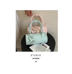 Fashionable mint green and pink woven barrel bags with star charms and braided texture