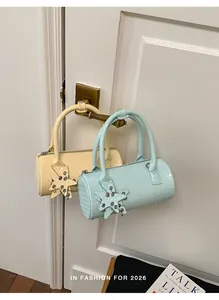 Close-up of pastel woven pillow bags hanging on a door handle in mint and cream