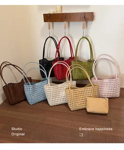 Multiple colorful woven tote bags with hollow out design displayed in a studio.
