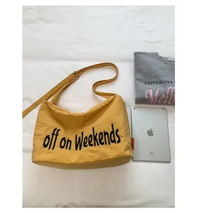Casual yellow nylon crossbody bag with off on Weekends text alongside iPad prop