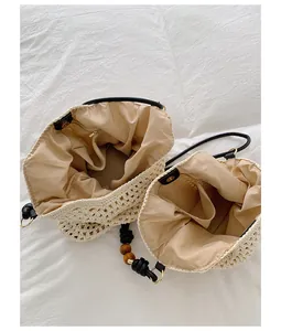 Close-up interior of large handmade woven straw beach tote bag with zipper pocket