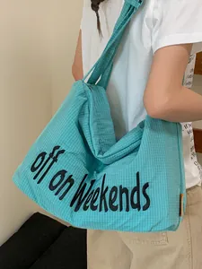 Large turquoise checkered nylon tote bag featuring 'off on Weekends' embroidery design