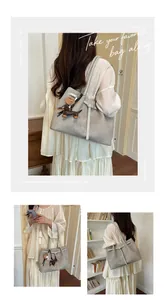 Detailed view of the large grey commuting tote bag styled with a cute dachshund charm