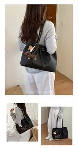 Premium large black tote bag with cute dachshund charm shown in various lifestyle poses