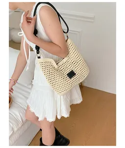 Elegant hand-woven straw hobo bag featured in a lifestyle setting for beach vacations