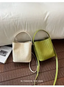 Detailed macro view showing the texture of woven bucket bags in cream and lime green