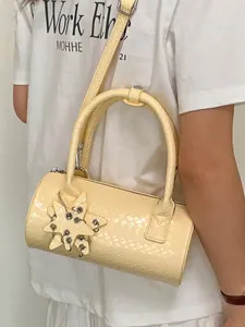 Elegant cream woven pillow handbag featuring a unique star charm and crossbody strap
