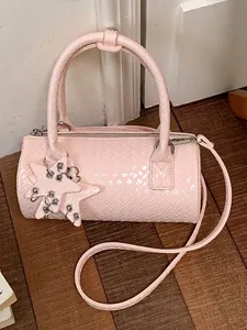 Pink woven cylinder barrel bag with star charm and detachable crossbody strap
