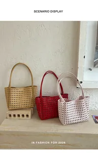 Three colorful hollow-out woven tote bags displayed on a textured stone surface