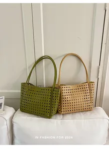 Detailed macro shot of fashionable woven hollow-out tote bags in green and beige finishes.