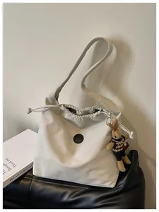Close-up of minimalist nylon drawstring tote bag with cute rabbit charm detail