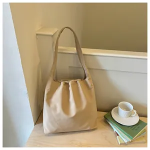 Detailed shot of a lightweight beige nylon shoulder bag in a cozy commute setting