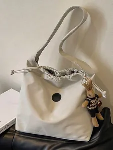 Minimalist white nylon shoulder bag with drawstring closure and cute rabbit keychain charm