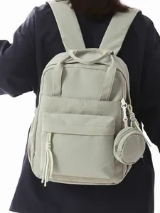 Stylish light green women's backpack for school and commuting with small round pouch
