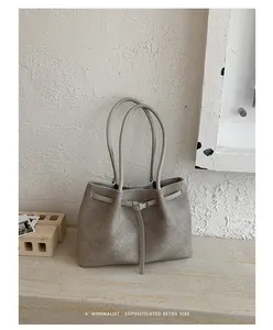 Minimalist large capacity tote bag with textured fabric and thin belt detail for women