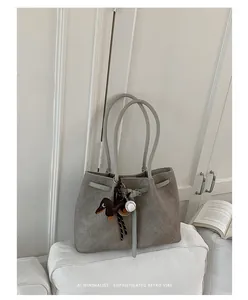Elegant grey textured large capacity tote bag with cute charms in a minimalist room setting
