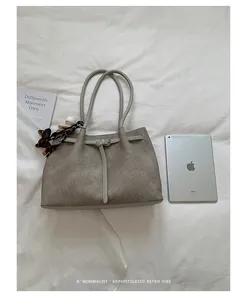 Sophisticated large grey commute tote bag shown next to an iPad for size comparison