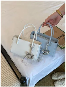 Elegant minimalist rectangular handbags in white and light blue featuring a silver horse charm