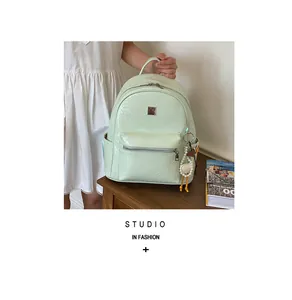 Stylish mint green women's backpack with woven texture and large capacity detail view.