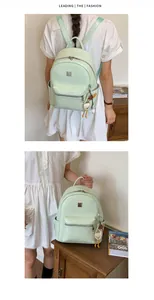 Detail view of a mint green fashion backpack for women with woven texture and cute charm