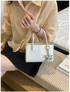 Chic white mini handbag for women featuring a stylish silver horse charm detail