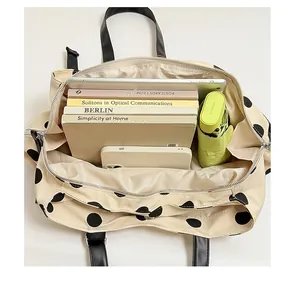 Detailed interior view of a large capacity polka dot tote bag showing ample storage space.