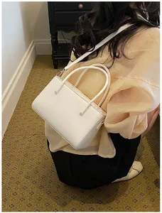 Elegant white rectangular handbag with top handles and strap for summer commuting