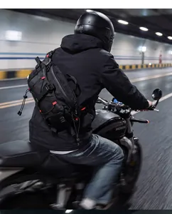Back view of a motorcycle rider wearing a black tactical crossbody bag in a tunnel